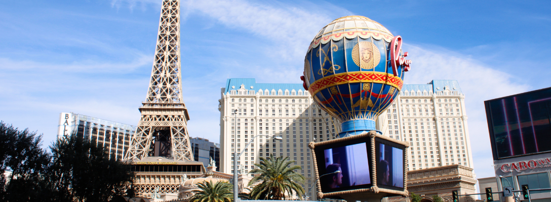 View across lake to replica Eiffel Tower at the Paris Hotel and Casino,  Bellagio fountains in